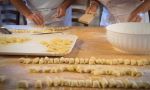 hand made pasta being rolled by two people
