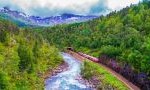 train along river in mountains